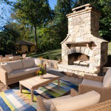 Outdoor fireplace and patio with patio furniture.